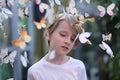 Portrait of a child among paper butterflies