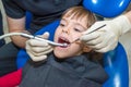 A portrait of a child patient in a dental chair in a dentistÃ¢â¬â¢s office