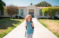 Portrait of child pupul with rucksacks in the park near school. Schoolboy with backpacks outdoors. School building