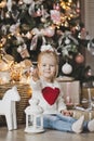 A little girl sitting under the Christmas tree with gifts 7240. Royalty Free Stock Photo