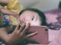 Portrait of a child sleeping while holding a smartphone