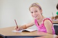 Portrait, child and smile of student learning in classroom for knowledge, education or development. Happy, girl and Royalty Free Stock Photo