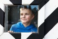 Child in striped black and white guard booth