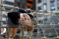 Portrait of a child upside down with positive emotions on the playground. Happy girl