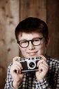 Portrait, child and vintage for camera with happiness, mockup and positive in glasses by backdrop. Boy, smile face and Royalty Free Stock Photo