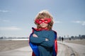 Portrait of child wearing a superhero costume. Super hero child against blue summer sky background. Kid having fun Royalty Free Stock Photo