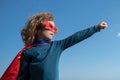 Portrait of child wearing a superhero costume. Super hero child having fun outdoors. Kids power concept. Royalty Free Stock Photo