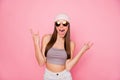 Portrait of childish person teen making horns shouting grimacing wearing eyewear eyeglasses isolated over pink Royalty Free Stock Photo