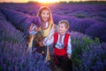 Portrait of children boy and girl in traditional Bulgarian folklore costume in lavender field during sunset