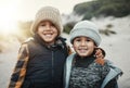 Portrait, children and brothers on the beach together during summer on holiday or vacation in nature. Kids, sand and