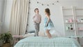 Portrait of children jumping on a bed, little boy and girl brother and sister have fun and laughing