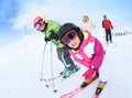 Portrait of children learning skiing with family Royalty Free Stock Photo