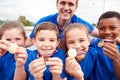 Portrait Of Children With Male Coach Showing Off Winners Medals On Sports Day Royalty Free Stock Photo