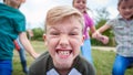 Portrait Of Children On Outdoor Activity Camping Trip Pulling Faces Having Fun Playing Game Together Royalty Free Stock Photo