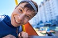 Portrait of children playing on the playground next to a condominium. Swing, slide, stairs, multistory building. A place for