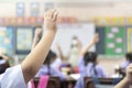 Portrait of children raised their hands in a classroom Royalty Free Stock Photo