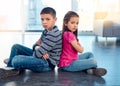 Portrait, children and sitting with arms crossed after fight, anger and backs together on floor in house. Angry, brother