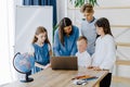 Portrait of children and teacher looking at laptop in the classroom Royalty Free Stock Photo