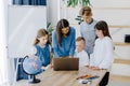 Portrait of children and teacher looking at laptop in the classroom Royalty Free Stock Photo