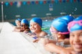 Portrait Of Children In Water At Edge Of Pool Waiting For Swimming Lesson Royalty Free Stock Photo