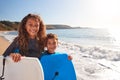 Portrait Of Children Wearing Wetsuits Holding Bodyboards On Summer Beach Vacation Having Fun By Sea Royalty Free Stock Photo