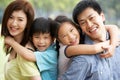 Portrait Of Chinese Family Relaxing In Park