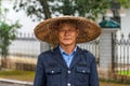 Portrait of Chinese man in traditional straw wide-brimmed hat
