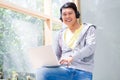 Chinese young man wearing casual clothes while using a laptop Royalty Free Stock Photo