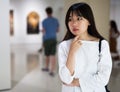 Chinese young woman near picture collection in the museum