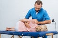 portrait of chiropractor massaging back of patient that lying on massage table Royalty Free Stock Photo