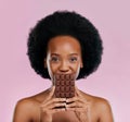 Portrait, chocolate and black woman with snack, natural beauty and sugar treat on a studio background. Face, female