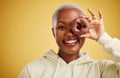 Portrait, chocolate and donut with a black woman in studio on a gold background for candy or unhealthy eating. Eye, food