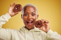 Portrait, chocolate and donut with a black woman in studio on a gold background for candy or unhealthy eating. Smile