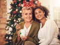 Portrait, christmas and blended family with a woman and daughter in law together in a home during the festive season Royalty Free Stock Photo