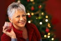 Portrait, Christmas and present for mature woman, smile and box for celebration. Tree, decoration and gift for Christian Royalty Free Stock Photo