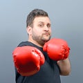 Portrait of chubby boxer posing with boxing gloves Royalty Free Stock Photo