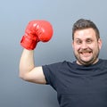 Portrait of chubby boxer posing with boxing gloves as a champion Royalty Free Stock Photo