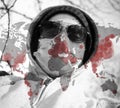 Portrait of a citizen with the protective mask and glasses and a world map with corona virus