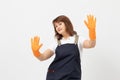 Portrait of cleaning lady with protective gloves ready to clean over light background