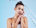 Portrait, cleaning and woman with water, skincare and luxury treatment against blue studio background. Face, female or