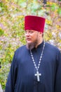 portrait of a clergyman with a cross on a city holida