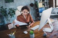 Portrait of clever company accountant lady sitting chair read clipboard documents desk loft office indoors