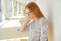 Portrait of clever student with open book reading it in college. Beautiful female student in a university, woman in eyeglasses Royalty Free Stock Photo