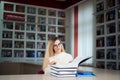 Portrait of clever student with open book reading it in college library. Royalty Free Stock Photo