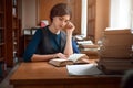 Portrait of clever student in university library.