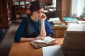 Portrait of clever student in university library.