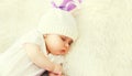 Portrait close-up baby sleeping in white knitted hat at home on bed Royalty Free Stock Photo