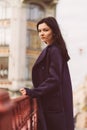 Portrait close-up of beautiful intelligent brunette who walks down street of St. Petersburg in city center. Charming thoughtful