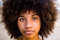 Portrait and close up of beautiful young African or American woman looking at the camera Royalty Free Stock Photo