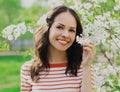 Portrait close up beautiful young woman in a spring blooming garden on a white flowers background Royalty Free Stock Photo